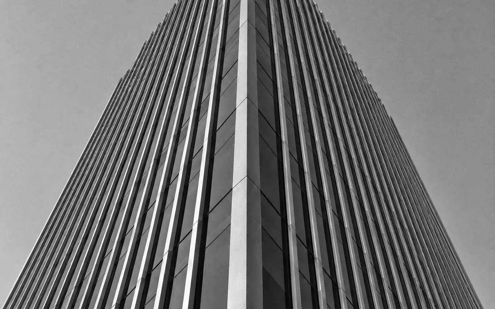 Ribbed facade of a tower seen from below